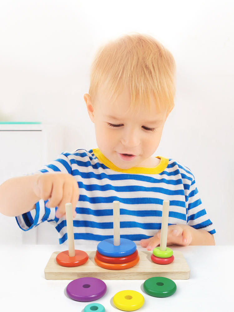 Child playing with the Large Wooden Tower of Hanoi - Educational Toy for Kids, enhancing problem-solving skills.